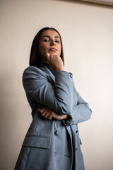 Elegant Fashion Portrait of a Woman in Grey Dress Shirt and Blazer with Brown Hair.