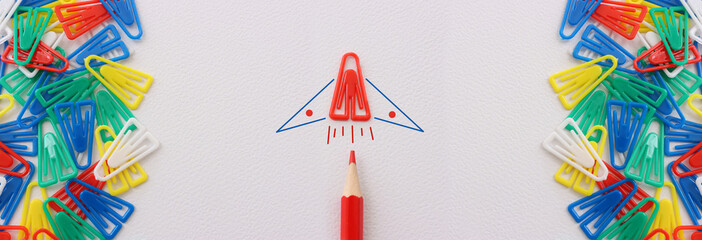 Concept image of unique thinking. Paper clips in the shape of airplane. Idea of teamwork and leadership