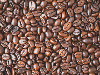 Roasted coffee beans forming a background pattern