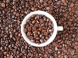 Roasted coffee beans forming a background pattern