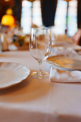 An empty wine glass on a table served for a banquet. 