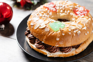 Individual chocolate Epiphany cake roscon de reyes on wooden table