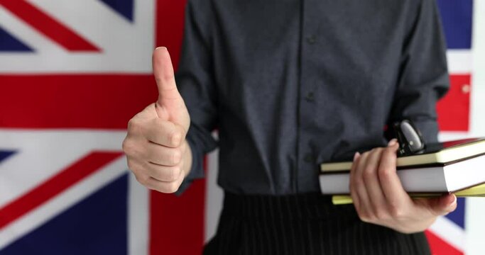 Foreign woman holding thumb up and UK flag. Approved and recommended education in London