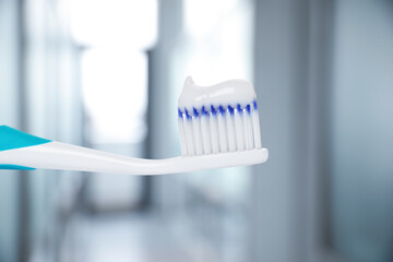 Fototapeta na wymiar Toothbrush with toothpaste against blurred background, closeup
