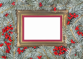 Elegant gold frame on a wintery evergreen backdrop with red berries, perfect for Christmas greetings, seasonal promotions, or festive designs with ample white space for custom text.