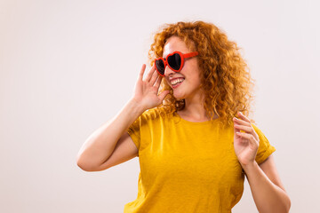 Image of happy ginger woman with red heart shaped sunglasses.