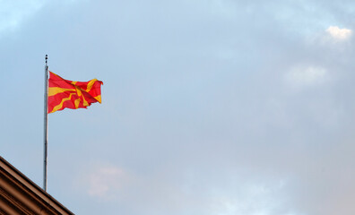 The national flag of North Macedonia waving in the wind in Skopje