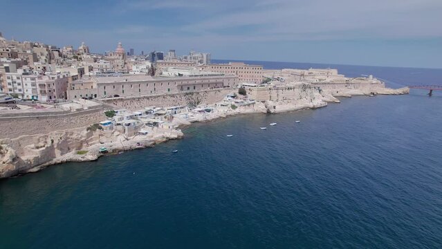 Aerial panoramic drone footage of Valletta, UNESCO World Heritage Site, Fort St Elmo, St. Paul's Cathedral, Grand Harbor Waterfront, Valletta, Malta