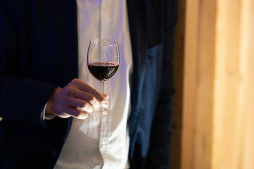 Hand holding a wine glass