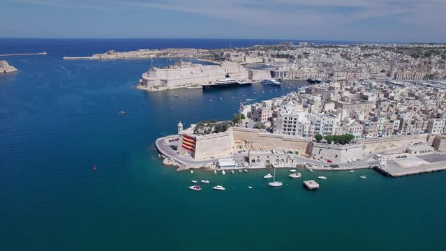 Aerial panoramic drone footage of Valletta, UNESCO World Heritage Site, Fort St Elmo, St. Paul's Cathedral, Grand Harbor Waterfront, Valletta, Malta