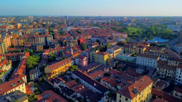 Aerial view of Milan cityscape. The theatrical performance is filmed in the air. Milano-Darsena area. Darsena freshwater canals in the city. Roof. reflection. Milan, Italy, 10.2023