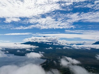 Obraz premium Scenic vista of Osorno Volcano in the distance, with fluffy white clouds dotting the horizon.