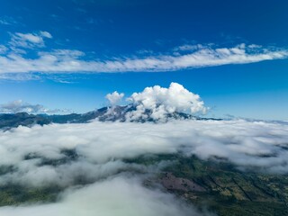Scenic vista of Osorno Volcano in the distance, with fluffy white clouds dotting the horizon.