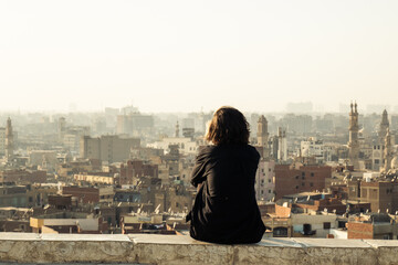 Fototapeta na wymiar Woman enjoying the view of the panoramic city of Cairo, Egypt.