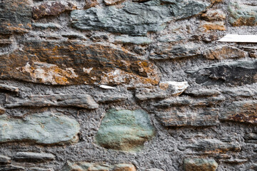 Old stone wall made of mossy stones texrure, pattern, wallpaper