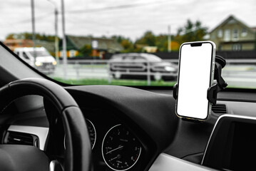 Close up of universal car phone holder with white smartphone screen on windshield.