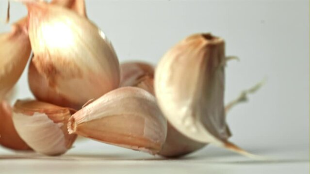 Fresh garlic falls on the table. Filmed on a high-speed camera at 1000 fps. High quality FullHD footage