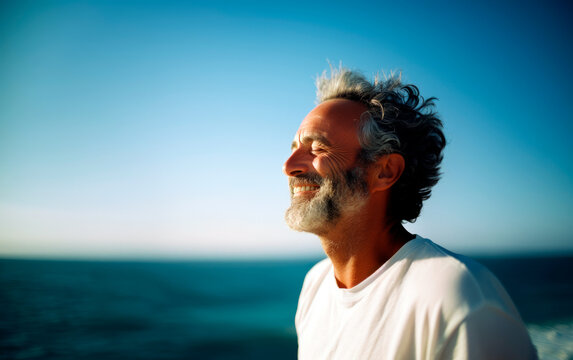 Middle-age man breathing fresh air in the beach.