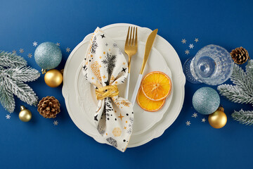 Get ready to deck the halls of your Christmas table. Top view photo of cutlery, plates, glassware,...