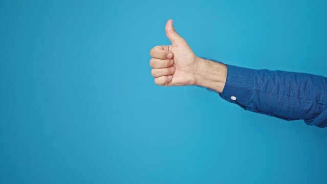 Young hispanic man with thumb up over isolated blue background