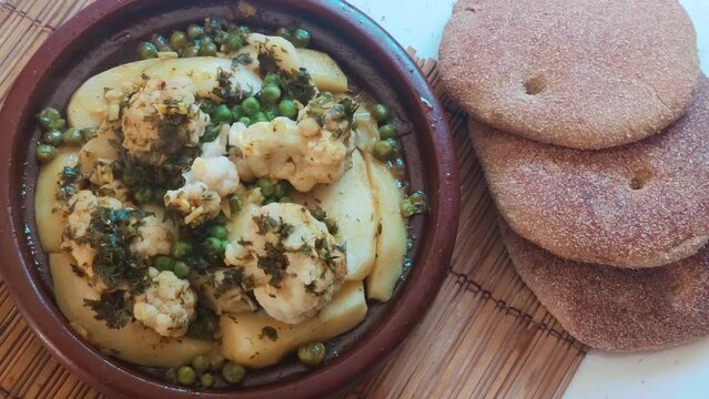 Close-up of a Moroccan Tagine served with traditional bread