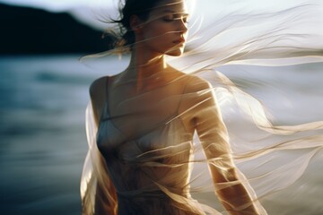 A beautiful woman in a modern dress at the beach at the golden hour. A shot of a model in a magazine-style fashion film photograph - obrazy, fototapety, plakaty