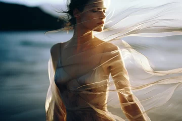 Gartenposter Sonnenuntergang am Strand A beautiful woman in a modern dress at the beach at the golden hour. A shot of a model in a magazine-style fashion film photograph