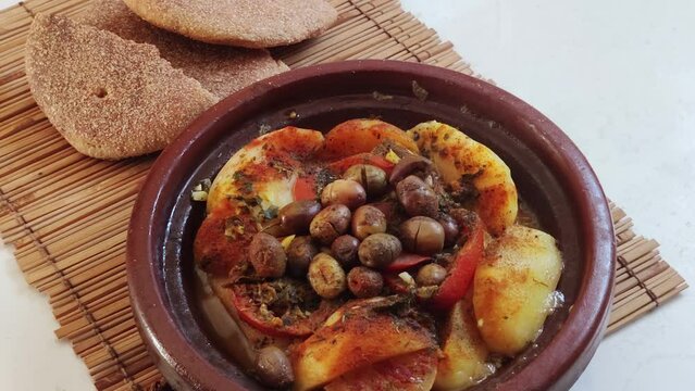 Close-up of a Moroccan Tagine served with traditional bread