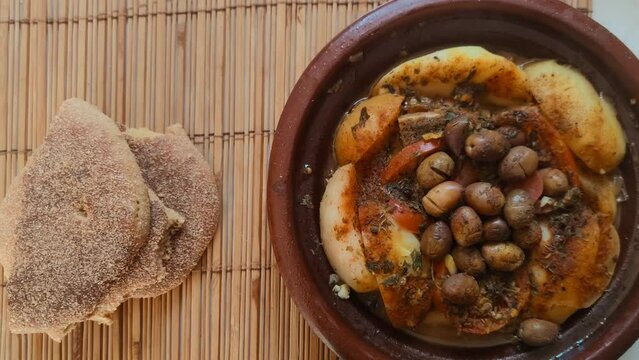 Close-up of a Moroccan Tagine served with traditional bread