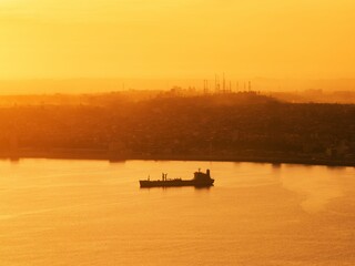 Aerial shot of the bay of the city of Puerto Montt with golden sunset light.