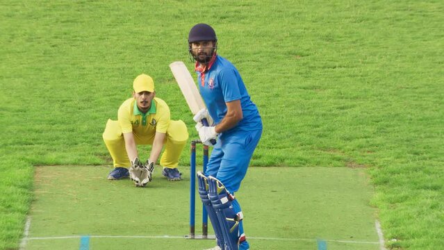 Team in Yellow Uniform Celebrating a Successful Match Win on Live TV Broadcast. Professional South Asian Teams Training Before a Cricket Tournament. Blue Team Batsman Failing to Run Across the Pitch