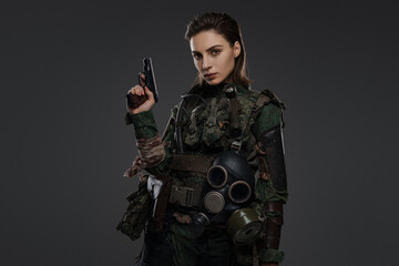 Female warrior dressed as a rebel or partisan in military garb, armed with a pistol, set against a neutral background, representing turmoil in the Middle East