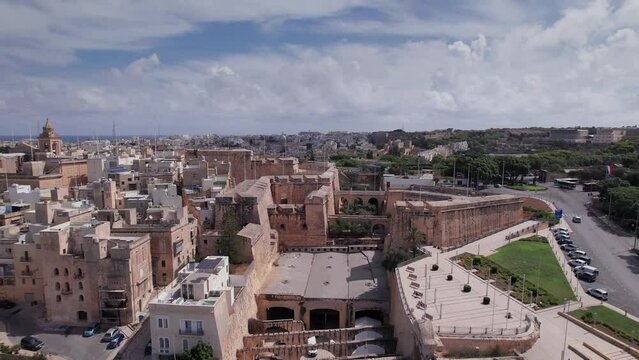 Aerial panoramic drone footage of Valletta, UNESCO World Heritage Site, Fort St Elmo, St. Paul's Cathedral, Grand Harbor Waterfront, Valletta, Malta