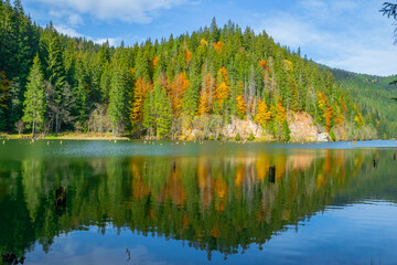 Red lake in autumn, natural dam lake, Romania