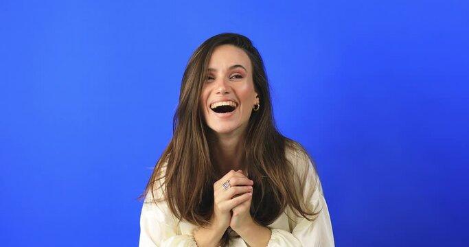 Amazed excited woman hairstyle in white dress open mouth in surprise looking at camera with big eyes, shocked isolated on blue background. Oh my god wow, yes gesture, win dance.