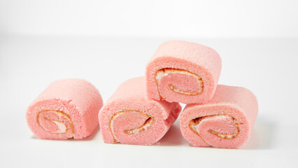 Strawberry roll cake on white background. Rose strawberry cake placed on a plate