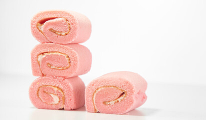 Strawberry roll cake on white background. Rose strawberry cake placed on a plate