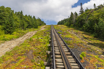 Steep, straight and disappearing behind the horizon  part of the cog railway on Mt Washington, New...