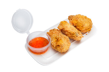 Vietnamese cuisine and food, breaded fried chicken wings with sauce on a plate, on a white isolated background