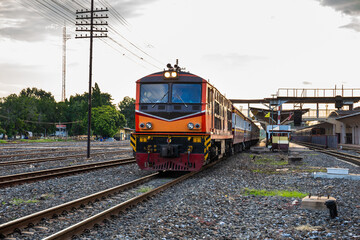Obraz premium Classic diesel trains transport passengers and tourists in Thailand at railway junctions.