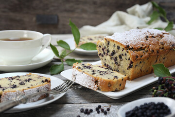 Summer baking. Black elderberry cake and cup of tea for summer tea party - 668701515