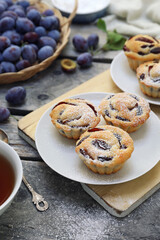 Plum muffins and cup of tea, powdered sugar dressing - 668701724
