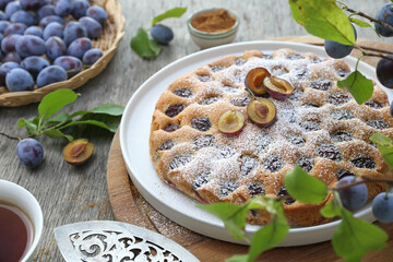 Homemade plum pie and cup of tea. New York Times recipe plum cake