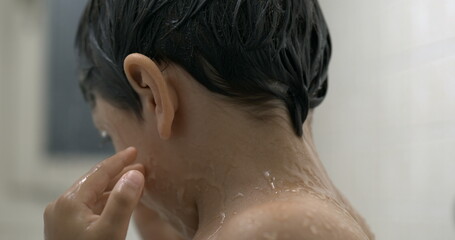 Child rubbing eyes during bath time , close-up kid face taking off soap from eye