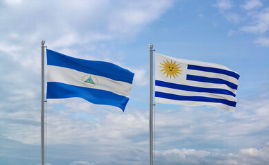 Uruguay and Nicaragua flags, country relationship concept