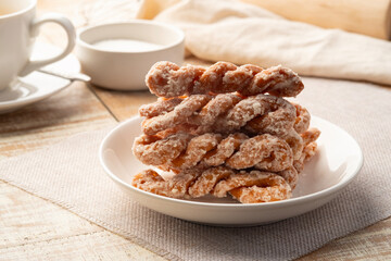 Puffy Twist Donut,mildly sweet and fluffy,twisted sugar doughnuts in white plate