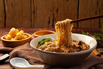 Close up use chopsticks clamp Rice Vermicelli ,Thai Boat Noodle Soup, Thailand's most famous noodle...