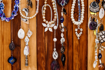 Fototapeta premium Handmade Jewelry Hanging from Rustic Wood