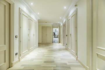 Large dressing room with access to a bedroom with fireplace and many built-in wardrobes