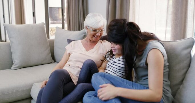 Grandmother, hug or mom with child in home for care, safety or bond together to relax on sofa. Smile, grandma or happy woman with girl or kid for support, trust or comfort in retirement as a family
